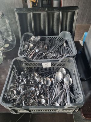 two baskets of silver spoons and spoon spoons on a table