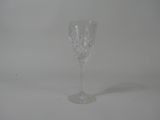an empty wine glass sitting on top of a white table