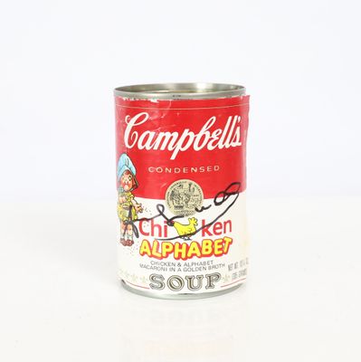 a can of campbell ' s chicken alphabet soup on a white surface