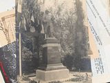 a pile of old photos and papers sitting on a table