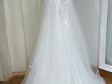 a dress on a mannequin stand in front of a mirror