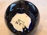 a close up of a black and white ball on a table