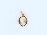 a close up of a gold plated pendant with a picture of a woman