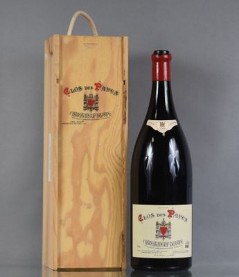 the bottle of wine is next to a wooden box