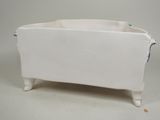 a white planter with a blue handle on it