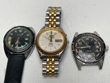 three different types of watches on a white surface with a white background