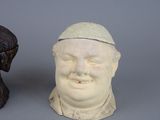two small statues of a man with a hat on