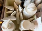 a box full of empty cups and saucers