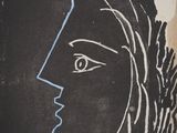 a black and white drawing of a woman ' s face on a wall