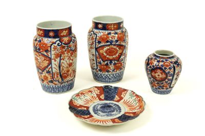 three vases and a plate sitting on a table