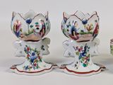 three vases that have been painted with flowers on them