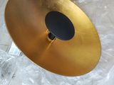 a gold plate with a black disc on top of it