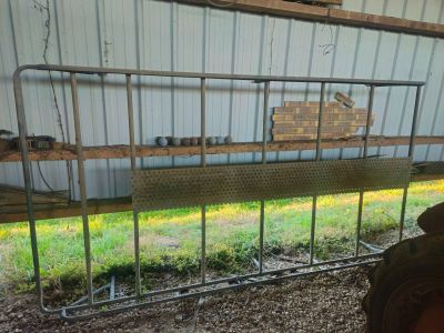 a metal fence that has a bunch of items on it