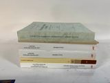 three books stacked on top of each other on a table