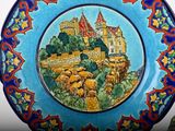 a blue plate with a picture of a castle on it