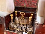 bottles and glasses in a wooden case on a wooden table