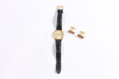 an image of a gold watch and cuff with a black leather strap