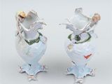 two vases that are decorated with birds and flowers