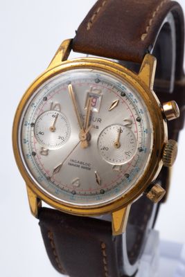 a close up of a wrist watch with a brown leather strap