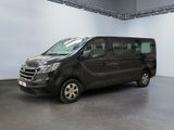 the black van is parked in a large room with a white wall