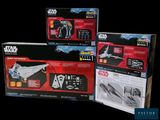 three star wars action figures sit in a box on a black background