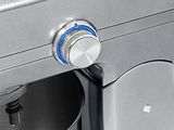 a close up of a silver mixer with a blue knob