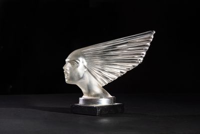 an image of a glass sculpture of a woman ' s head on a black surface