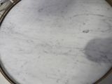 a white marble table with a gold frame around it