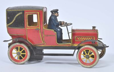 a red toy car with a man sitting in the driver ' s seat