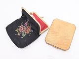 a small black purse with a floral design on it