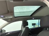 a view of a car ' s sunroof from inside the vehicle