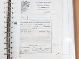 an old document on a table with a pen and a pencil