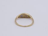 a gold ring with a blue sapphire stone set in the center