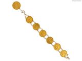 un gros plan d'un bracelet composé de pièces d'or sur fond blanc