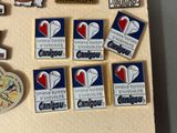a lot of pins and magnets on a table