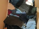 a cardboard box full of jeans and a pair of jeans