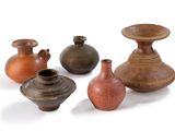 four vases that are sitting on a white surface