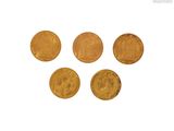 five gold coins are arranged in a row on a white surface
