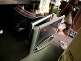 an image of a microwave in a room with a lot of stuff on the floor