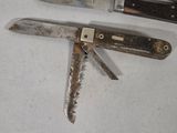 a knife that is laying on a table next to a knife