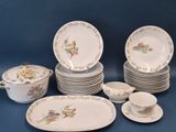many plates and cups and saucers on the table