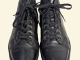pair of black leather shoes with laces on a white background