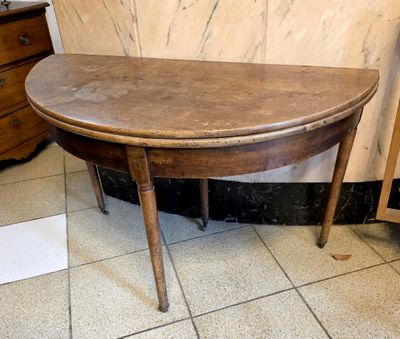 a small table with a wooden top on a tiled floor