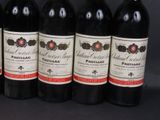 six bottles of wine are lined up in a row on a black background