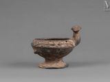 an image of a small brown vase with a bird on it ' s head