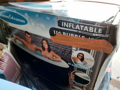 a box of inflatable bathtubs sitting on the ground
