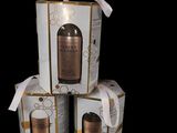 three boxes with a bottle of liquid sitting on top of each other