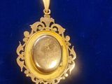 an image of a gold locke with a stone in it