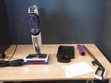 a vacuum that is sitting on a table with other items