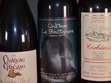several bottles of wine are lined up on a table